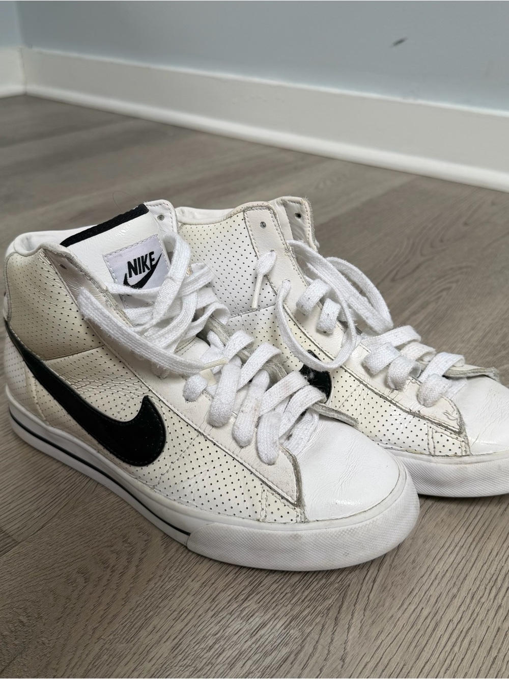 Nike Women's White High-Top Sneakers with Black Swoosh
